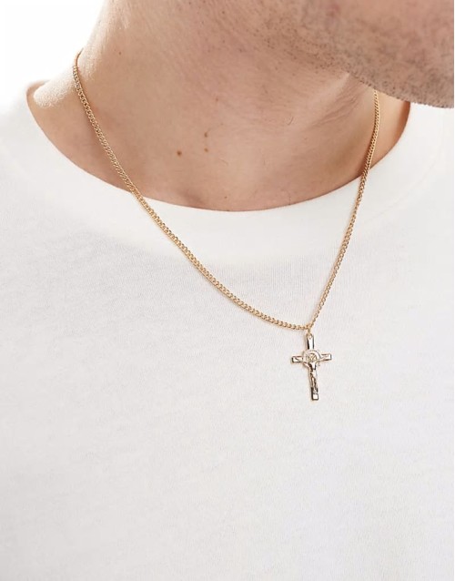 cross pendant with design in gold tone