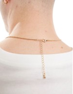 cross pendant with design in gold tone